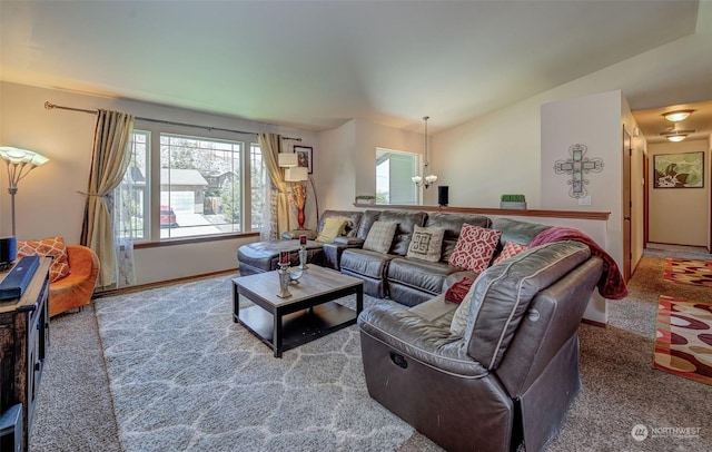 living room with carpet flooring, vaulted ceiling, and an inviting chandelier