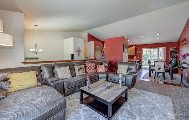 living room with lofted ceiling, carpet floors, and a chandelier