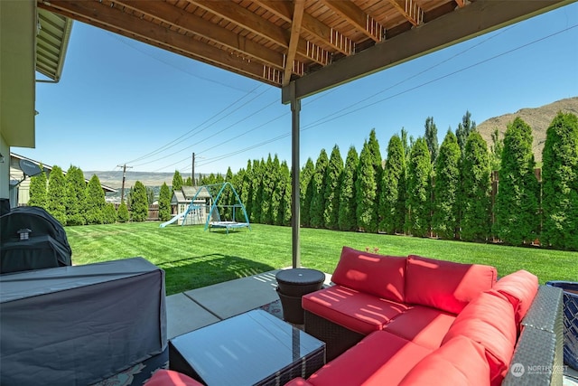 view of patio with outdoor lounge area, a playground, and grilling area