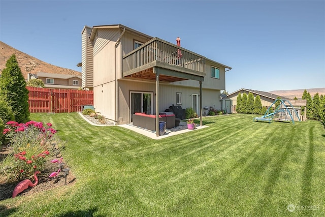 back of house with an outdoor hangout area, a playground, a patio area, and a lawn