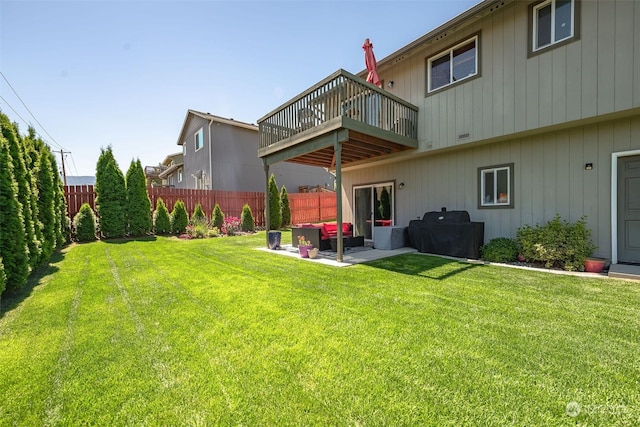 rear view of property featuring an outdoor living space, a balcony, a patio, and a lawn