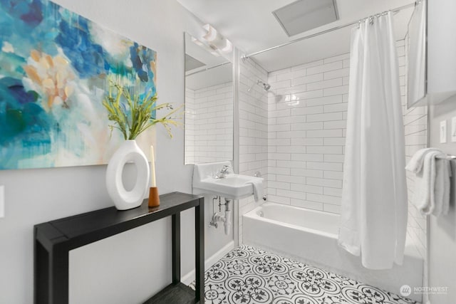 bathroom featuring sink, shower / tub combo with curtain, and tile patterned flooring