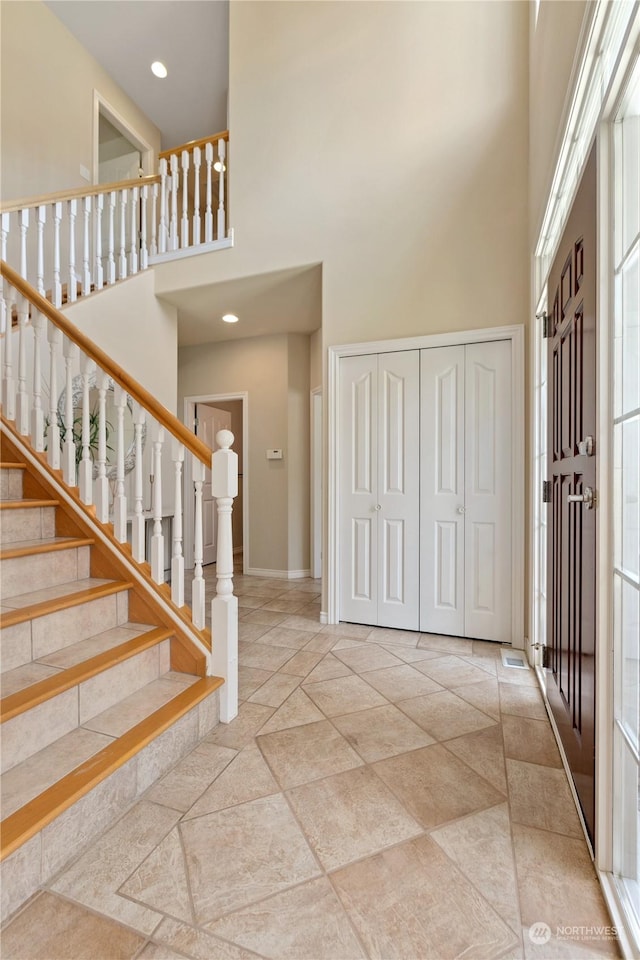 entryway with a towering ceiling and plenty of natural light