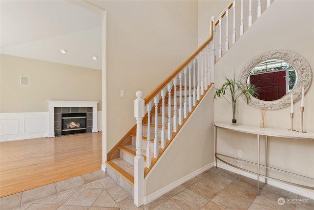 3377 Topaz Ct, Bellingham, WA 98226 - stairway with a towering ceiling, a tiled fireplace, and wood finished floors