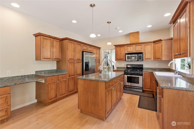 3377 Topaz Ct, Bellingham, WA 98226 - kitchen with appliances with stainless steel finishes, brown cabinets, a kitchen island, light wood finished floors, and recessed lighting