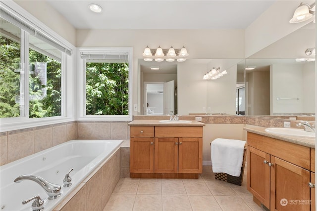 bathroom featuring tile patterned floors, vanity, and a relaxing tiled tub