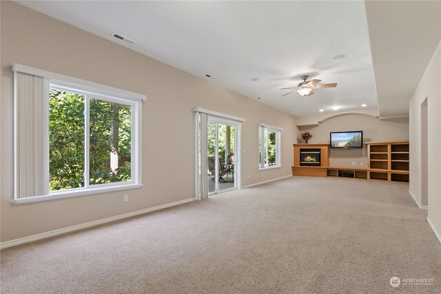 unfurnished living room featuring ceiling fan and light colored carpet