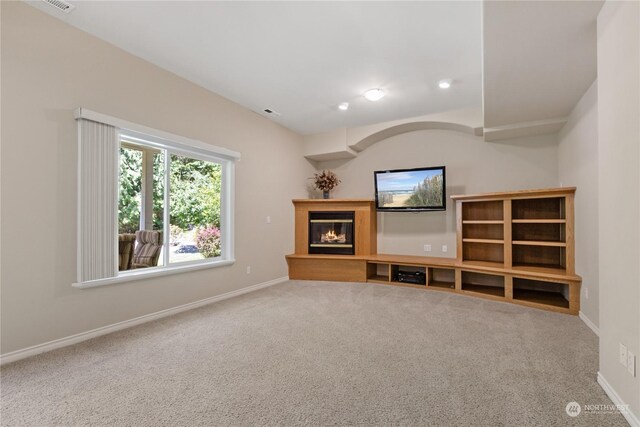 unfurnished living room featuring carpet flooring