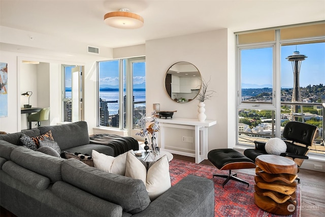 living room featuring a water view and wood-type flooring