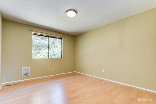 unfurnished room with light hardwood / wood-style floors