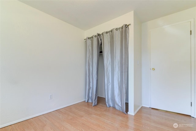 unfurnished room with light hardwood / wood-style floors