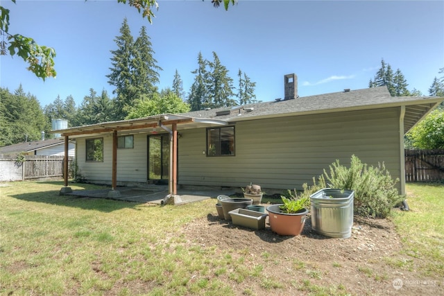 rear view of property featuring a lawn and a patio