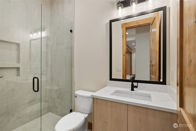 bathroom with vanity, toilet, and walk in shower