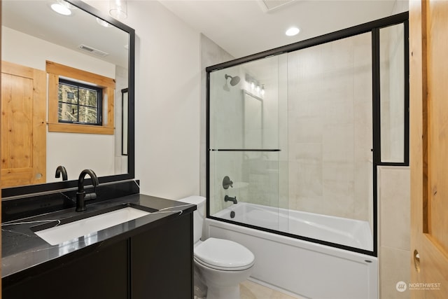 full bathroom with vanity, toilet, and enclosed tub / shower combo