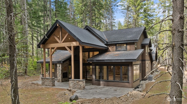 back of property featuring a fireplace, cooling unit, and a patio area