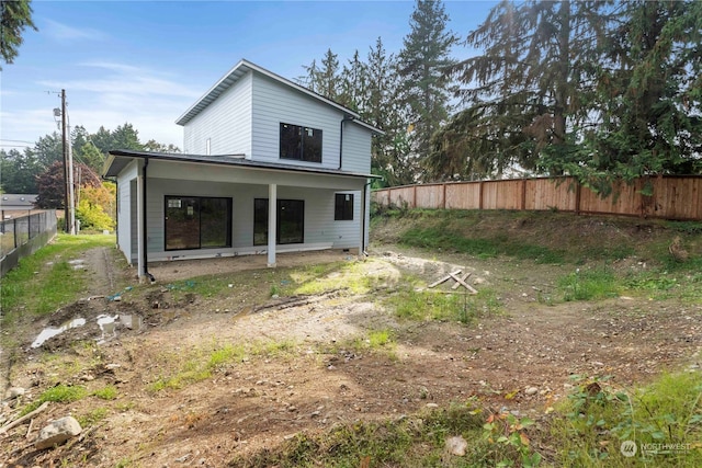 back of property with a patio