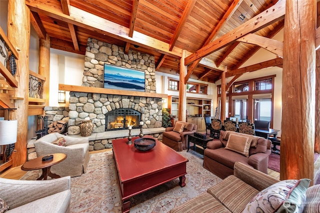 living room featuring wood ceiling, a fireplace, beam ceiling, and high vaulted ceiling