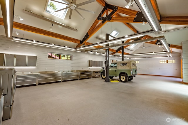 garage featuring wooden walls and ceiling fan