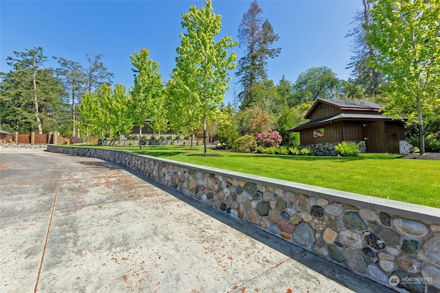 view of home's community with a yard