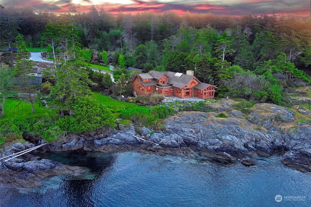 aerial view at dusk with a water view