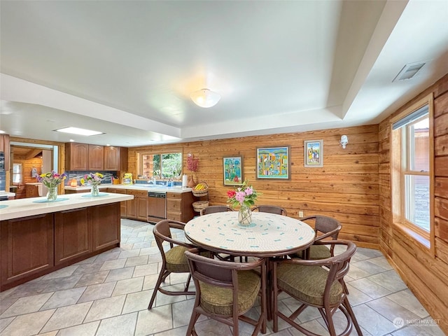 dining space featuring wooden walls