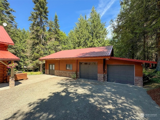 view of front facade featuring an outbuilding and a garage