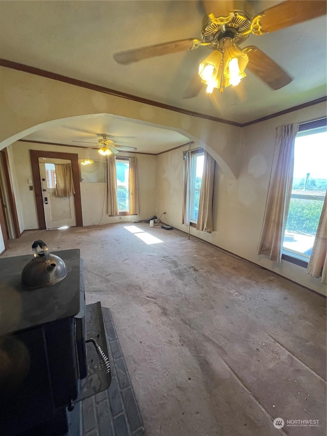 interior space with carpet flooring, ceiling fan, and crown molding