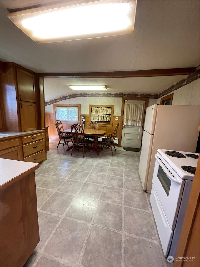 kitchen with electric stove and wooden walls