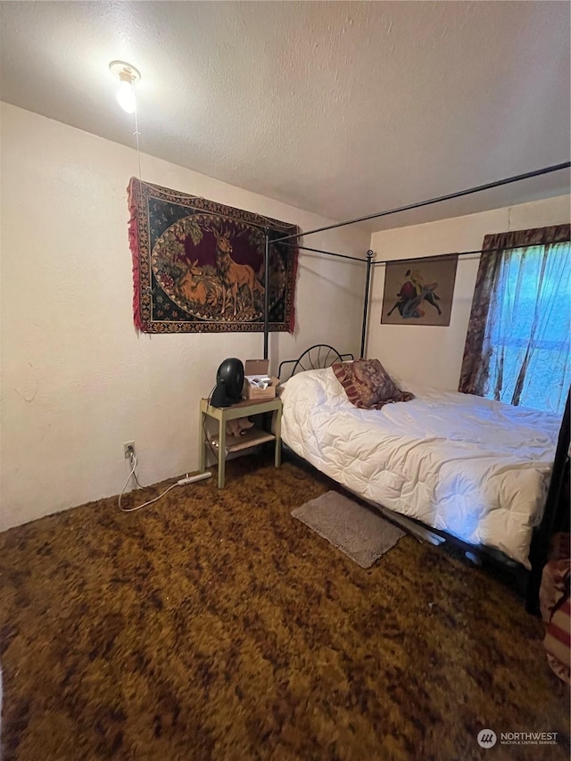 bedroom featuring carpet flooring and a textured ceiling