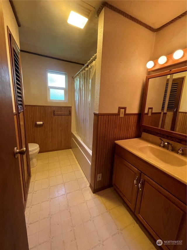 full bathroom featuring vanity, shower / bath combination with curtain, and toilet