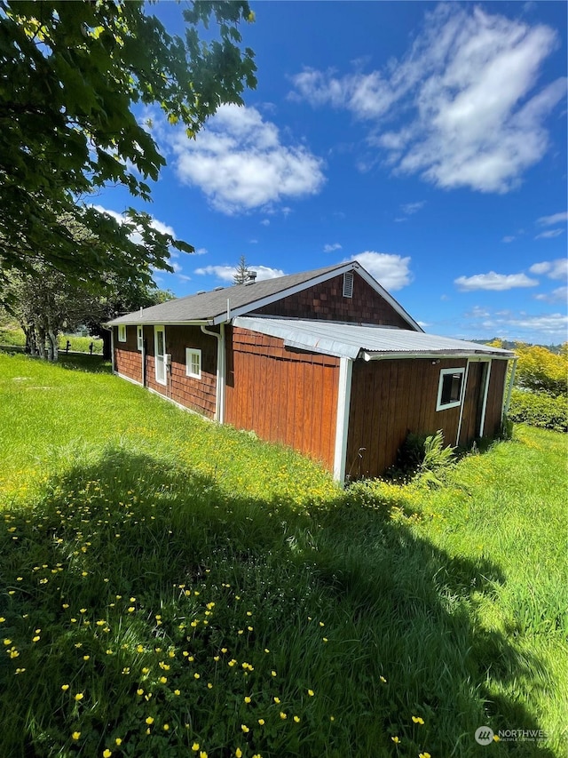 view of side of property with a lawn