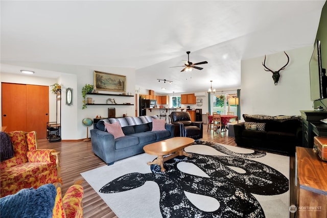 living room featuring light wood-type flooring, ceiling fan, and lofted ceiling