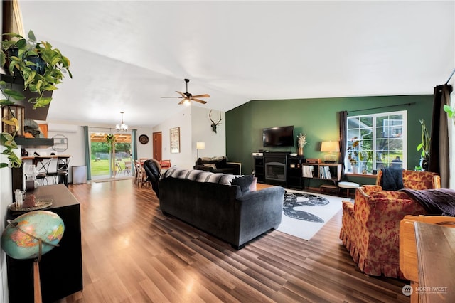 living room featuring a fireplace, wood-type flooring, ceiling fan with notable chandelier, and vaulted ceiling