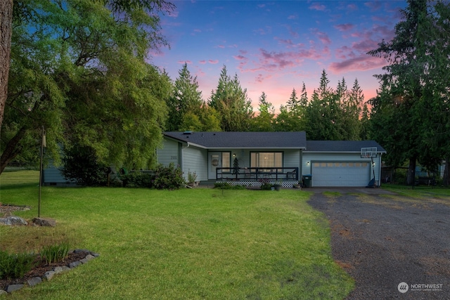 ranch-style house featuring a garage and a lawn