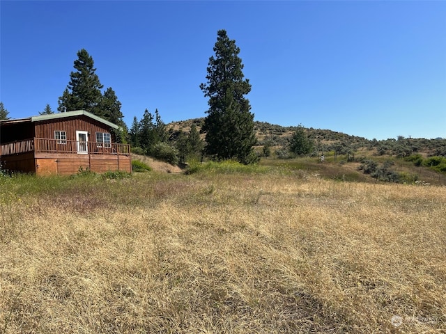 view of yard featuring a deck and a rural view