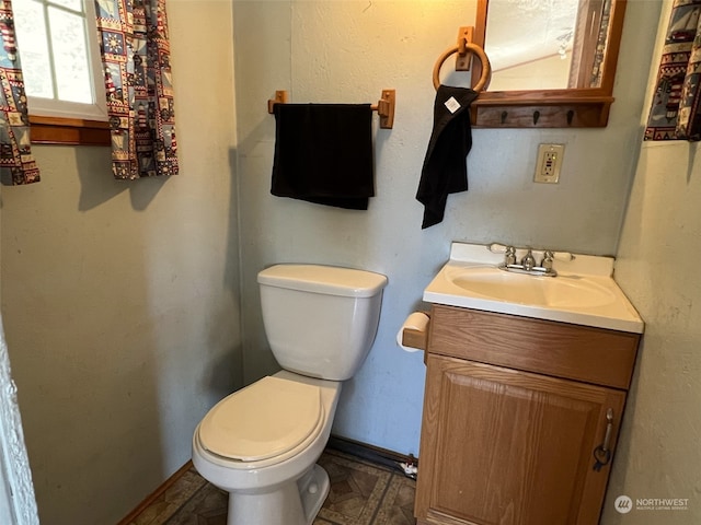 bathroom featuring tile flooring, toilet, and large vanity