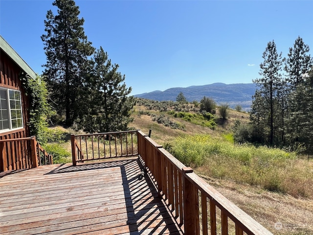 wooden deck featuring a mountain view