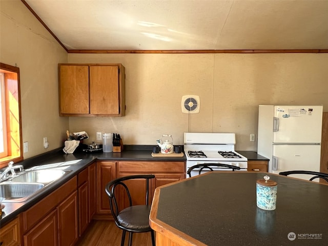 kitchen featuring crown molding, a breakfast bar area, hardwood / wood-style floors, sink, and white appliances