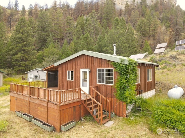 back of property featuring a deck