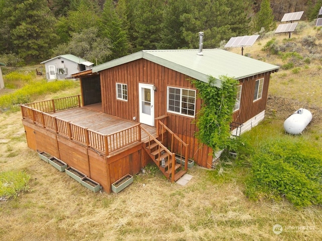 rear view of property featuring a wooden deck