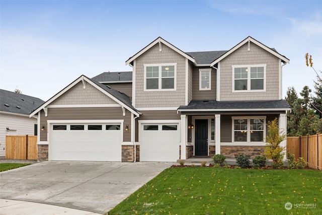 craftsman house featuring a garage, a front lawn, and a porch