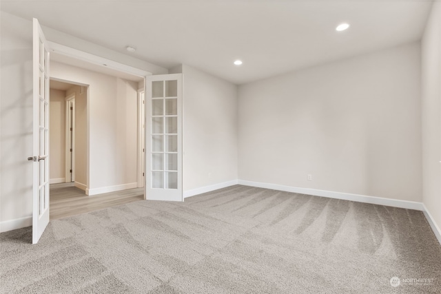 carpeted empty room featuring french doors