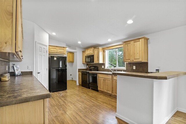 kitchen featuring decorative backsplash, light hardwood / wood-style floors, light brown cabinets, and black appliances