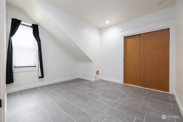 bonus room with tile flooring and plenty of natural light