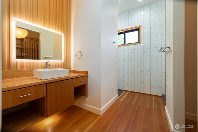 840 Shoshone Dr, La Conner, WA 98257 - bathroom with vanity, wood finished floors, baseboards, and tiled shower