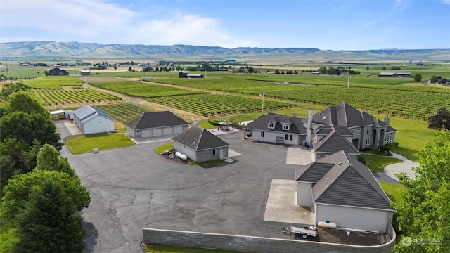 birds eye view of property with a mountain view and a rural view