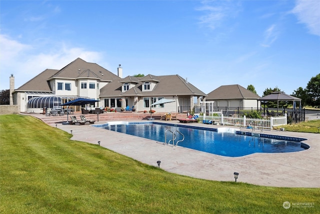 view of pool featuring a lawn, a gazebo, and a patio area