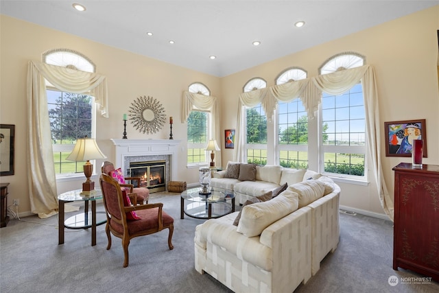 living room featuring a wealth of natural light, carpet, and a premium fireplace