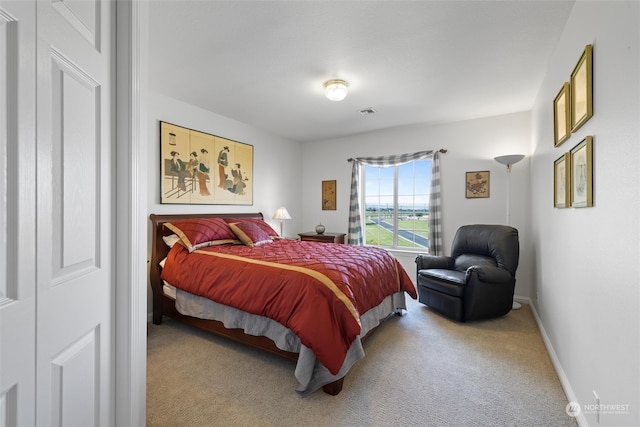 bedroom featuring light carpet