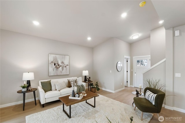 living room featuring light wood-style floors, recessed lighting, and baseboards